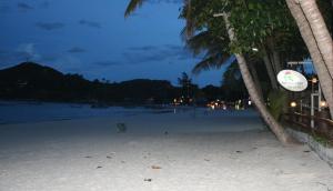 a frisbee is flying over a beach at night at Palita Lodge - SHA Plus in Haad Rin