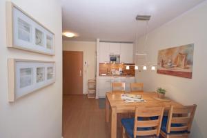 a dining room and kitchen with a table and chairs at Yachthafenresidenz-Wohnung-8308-863 in Kühlungsborn
