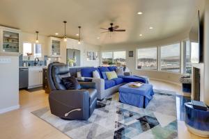 a living room with a blue couch and a kitchen at Dreamy Sonoma Coast Home with Waterfront Views in Bodega Bay