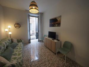 a living room with a couch and a television at From Pedrotti in Desenzano del Garda