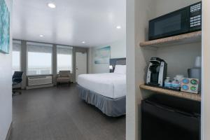 a hotel room with a bed and a television at Wyndham Corpus Christi Resort North Padre Island in Corpus Christi