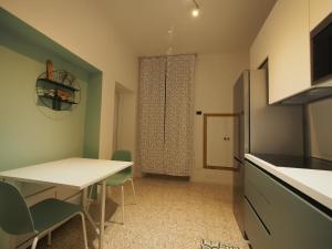 a kitchen with a table and chairs in a room at From Pedrotti in Desenzano del Garda