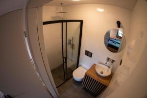 a bathroom with a toilet and a sink and a mirror at Poza Horyzont in Korbielów