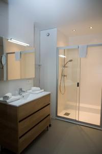 a bathroom with a shower and a sink at Hotel Residence Alaïa in Ascain