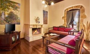 a living room with a couch and a fireplace at Villa Arhontiko In Arhanes in Archanes