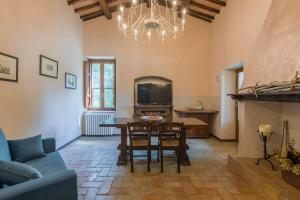 a living room with a table and a tv at Casale Andrea in Spoleto