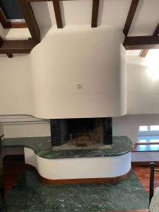 a fireplace in a living room with a white ceiling at Villa Livia in Fermo