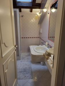 a bathroom with a tub and a sink and a mirror at Villa Livia in Fermo