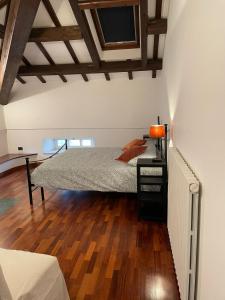 a bedroom with a bed and a wooden floor at Villa Livia in Fermo