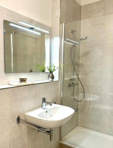 a bathroom with a sink and a shower at Residenz-Ostseewind-Wohnung-17-255 in Kühlungsborn