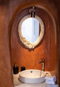 a bathroom with a sink and a mirror at Villa Ambrosia in Oia