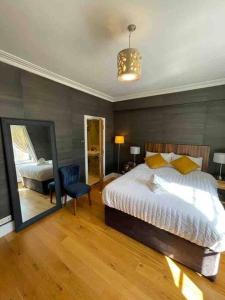 - une chambre avec un grand lit et un miroir dans l'établissement MODERN 2 BED 2 BATH CLOSE TO OXFORD STREET, à Londres