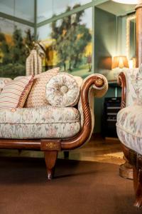 a living room with a couch and two chairs at FORESTERIA di PALAZZO RADICI in Bergamo