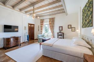 um quarto com uma cama grande e uma televisão em FORESTERIA di PALAZZO RADICI em Bérgamo