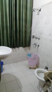 a bathroom with a toilet and a sink at Hotel Diamond palace 45C in Chandīgarh