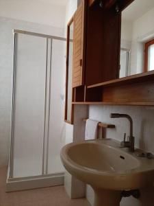 a bathroom with a sink and a glass shower at Casa Vacanza 30 in Galatina