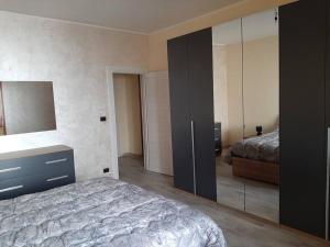 a bedroom with a bed and a large mirror at Casa Vacanza 30 in Galatina