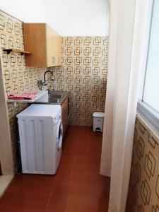 a small kitchen with a sink and a stove at Casa Vacanza 30 in Galatina