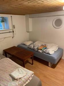 um pequeno quarto com uma cama e uma mesa em Rundvejen Guest House em Aalborg