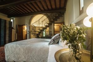 a bedroom with a large bed and a staircase at Chiesino Dei Vaioni in Pistoia