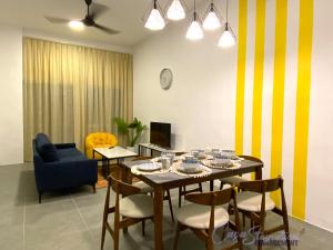 a dining room with a table and a blue chair at Casa Le Bliss (13) in Kuah