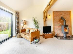 a living room with a couch and a fireplace at Pennant in Llangurig