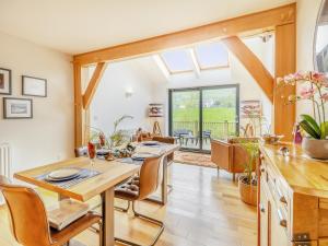 a kitchen and dining room with a table and chairs at Pennant in Llangurig