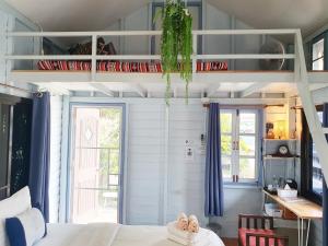 a bedroom with blue walls and a bed with shoes on it at KINN Stay50 Bangkok in Bangkok Yai