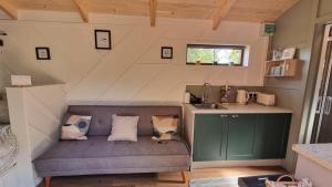 a tiny house with a bench in a room at LittleGreenGlamping in Leitrim
