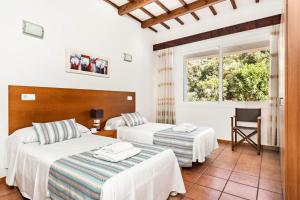 Habitación de hotel con 2 camas y ventana en Villa Olives by Villa Plus en Ferreries