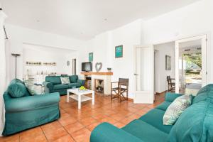 a living room with two blue couches and a table at Villa Olives by Villa Plus in Ferreries