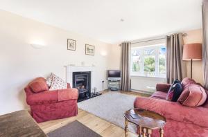 a living room with two couches and a fireplace at Pinellas Point in East Wittering