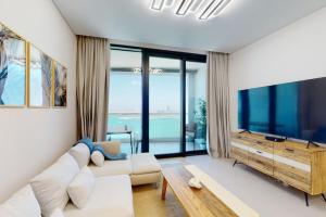 a living room with a large flat screen tv at Address Beach Residence, JBR - Vacationer in Dubai