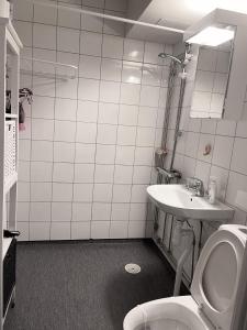 a bathroom with a toilet and a sink at Twayi Luxury Suites in Jönköping