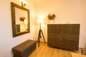 a living room with a dresser and a mirror at Apartament Oskar in Karpacz