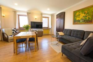 a living room with a couch and a table at Apartament Oskar in Karpacz