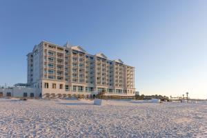 a hotel on the beach with a sandy beach at The Pensacola Beach Resort in Pensacola Beach