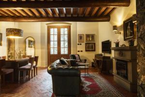 a living room with a couch and a fireplace at Chiesino Dei Vaioni in Pistoia