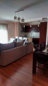 a living room with a couch and a table at Mollys2apartment in Pogradec