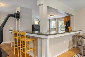 a kitchen with a large counter with two stools at The Brew House - 2nd Floor Private Apartment in Portland