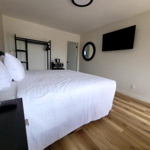 a bedroom with a large white bed and a television at Richland Inn and Suites in Richland