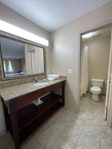 a bathroom with a sink and a mirror and a toilet at DELUXE INN in Warsaw +13 photos