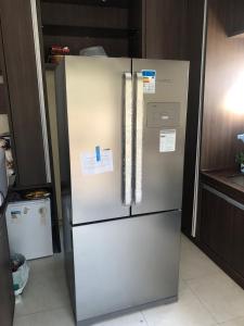 a refrigerator in a kitchen with papers on it at Solar dos Cataventos: Linda Casa com Piscina e Jacuzi in Florianópolis