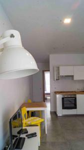 a kitchen with a table and yellow chairs in it at Nicely furnished 1 bedroom apartment in Gzira in Il-Gżira