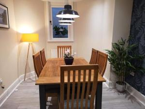 a dining room with a wooden table and chairs at Biskey Bowness in Bowness-on-Windermere