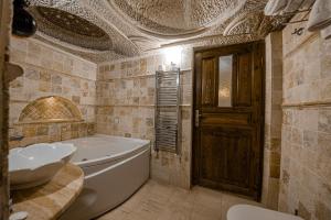 a bathroom with a tub and a sink at Konak Bezirhane Cave Otel in Urgup +68 photos