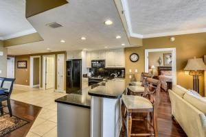 a kitchen and a living room with a counter top at Treasure Island 2202 in Panama City Beach