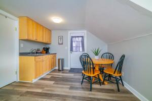 a kitchen with a table and chairs in a room at 2 beds, trailer parking, direct snow & ATV trail access in Gorham