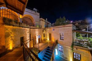 an old building with stairs and a stair case at Konak Bezirhane Cave Otel in Urgup