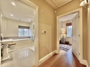 a bathroom with a toilet and a sink and a mirror at Beaufort Barn by inspirestays-com in Bignor +50 photos